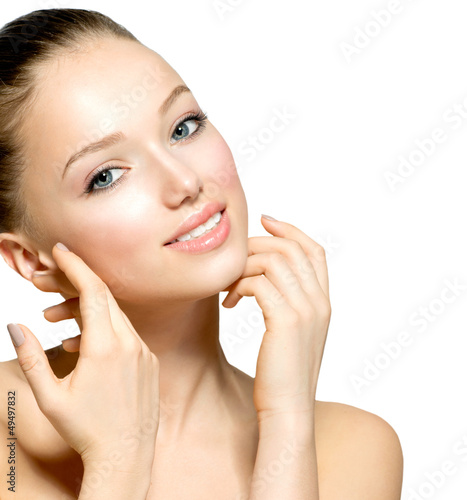 Photo: Beautiful Young Woman with Fresh Clean Skin touching her Face Beautiful Young Woman with Fresh Clean Skin touching her Face