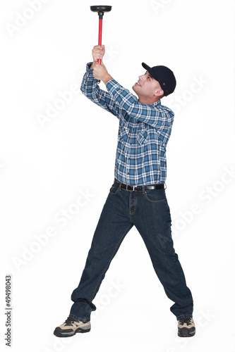 Photo: Man with a plunger Man with a plunger