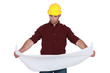 Tradesman examining a technical drawing