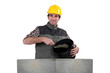 Bricklayer with a bucket of cement