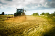 Tractor ploughs field