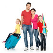 Photo: Happy family with suitcase at studio Happy family with suitcase at studio