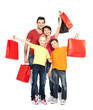 family with shopping bags standing at studio