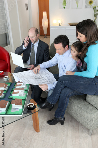 Photo: Architect sat with young family Architect sat with young family