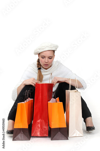 Photo: elegant woman looking in her shopping bags elegant woman looking in her shopping bags