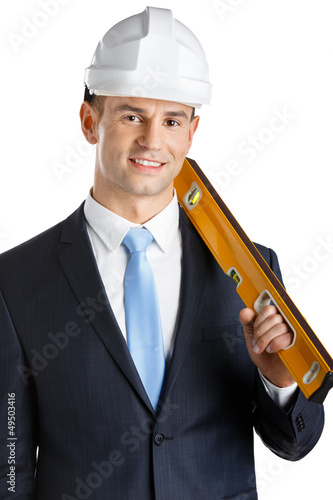 Photo: Engineer in headpiece keeps level, isolated on white Engineer in headpiece keeps level, isolated on white