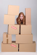 woman stood by pile of cardboard boxes