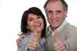 Couple giving the thumbs-up