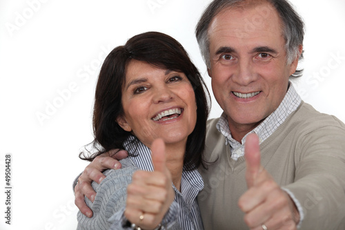 Photo: Couple giving the thumbs-up Couple giving the thumbs-up