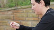 Sad woman holding a wedding ring profile