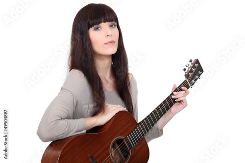Photo: Woman playing acoustic guitar Woman playing acoustic guitar