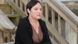 Sad woman sitting on wooden steps