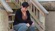 Sad woman sitting on wooden steps 2