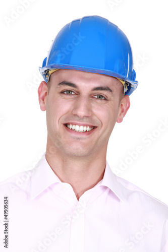 Photo: Smiling man wearing a hardhat Smiling man wearing a hardhat