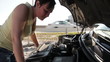 Woman looking at her car engine