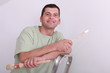 Cheerful painter on a ladder