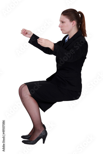 Photo: Businesswoman practicing breathing techniques Businesswoman practicing breathing techniques