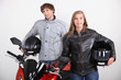 Couple stood with motorbike