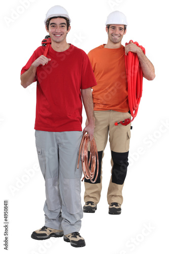 Photo: Two plumbers with modern and traditional materials Two plumbers with modern and traditional materials