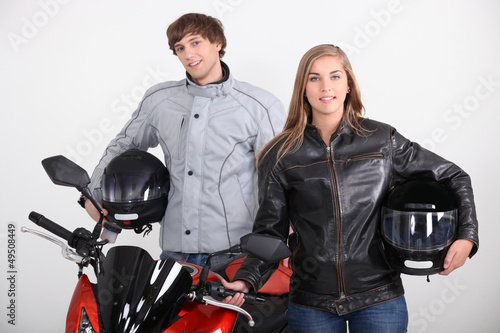 Photo: Couple stood with motorbike Couple stood with motorbike