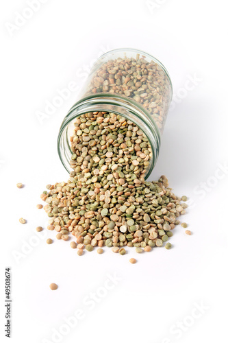 Photo: Dried lentil spilling from glass jar Dried lentil spilling from glass jar