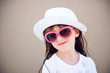 Photo: Portrait of little girl in hat and sunglasses Portrait of little girl in hat and sunglasses