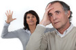 A middle age couple having an argument.
