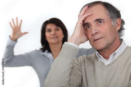 Photo: A middle age couple having an argument. A middle age couple having an argument.