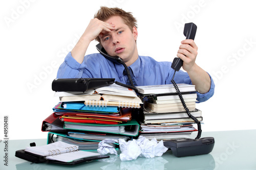Photo: An overwhelmed businessman. An overwhelmed businessman.