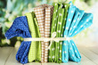 Color mottled fabrics on wooden table on natural background