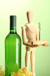 Mannequin with corkscrew and wine bottle, on green background