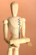 Mannequin with corkscrew, on brown background