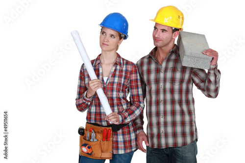 Photo: Tradesman and tradeswoman looking sideways Tradesman and tradeswoman looking sideways