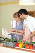Couple following a recipe book