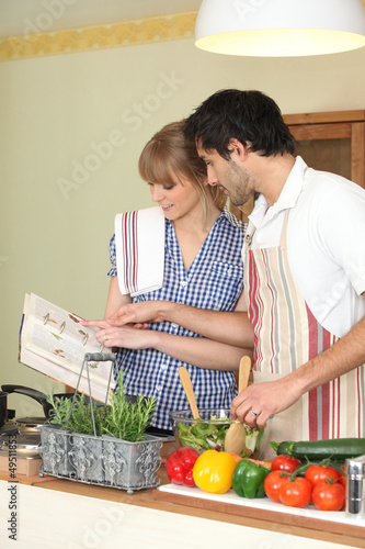 Photo: Couple following a recipe book Couple following a recipe book
