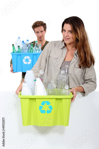 Photo: Couple recycling boxes of plastic bottles Couple recycling boxes of plastic bottles