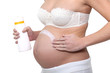 pregnant woman applying cream on her belly