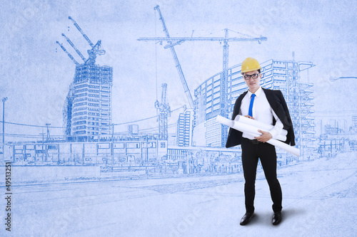 Photo: Engineer holds blueprints Engineer holds blueprints