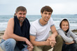 Men of different age on the beach.