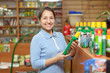mature  woman chooses fertilizers at store