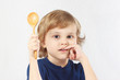 Little boy holding a wooden spoon on white background