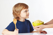 Mom takes a plate of porridge to her little child