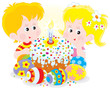 Girl and boy with a colorful Easter cake and eggs