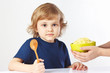 Beautiful blonde child is going to have breakfast cereal