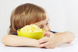 Beautiful child hugging a bowl of porridge favorite