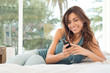 Happy Young Woman Listening To...