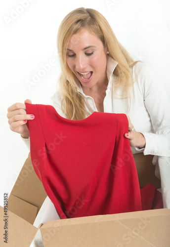 Photo: Happy woman with online clothes purchase Happy woman with online clothes purchase