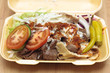 A doner kebab in styrofoam container