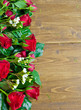 Wooden background with red roses