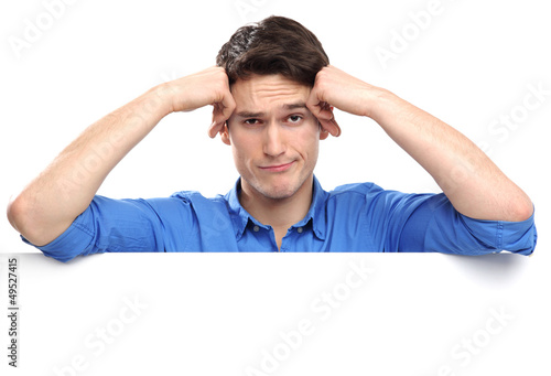Photo: Unhappy man leaning on whiteboard Unhappy man leaning on whiteboard